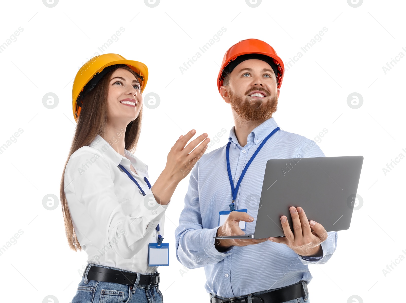 Photo of Engineers in hard hats with laptop on white background