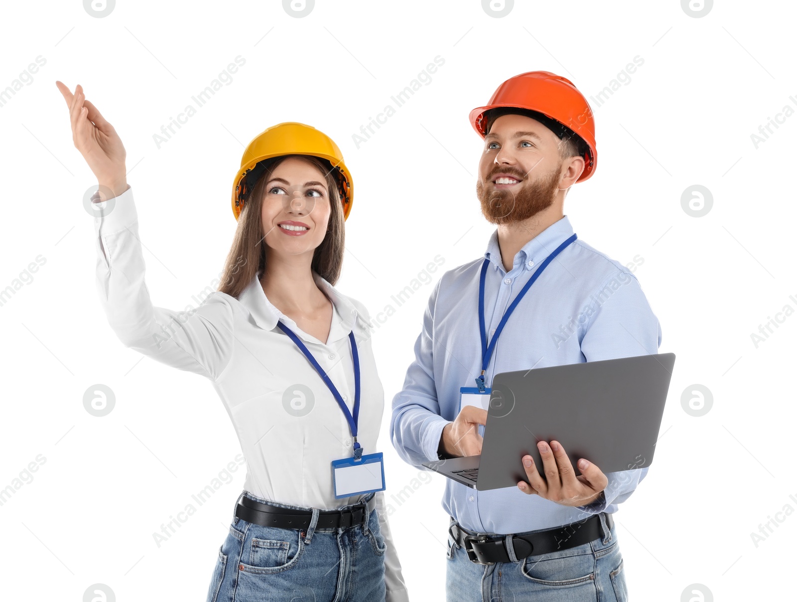 Photo of Engineers in hard hats with laptop on white background