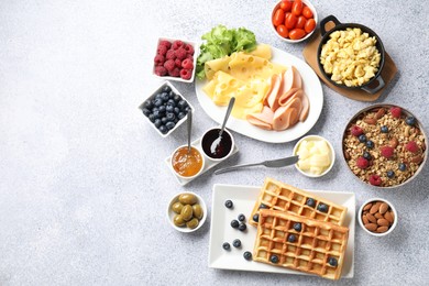 Photo of Tasty breakfast. Flat lay composition with many different food on grey textured table. Space for text