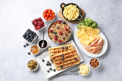 Photo of Tasty breakfast. Flat lay composition with many different food on grey textured table