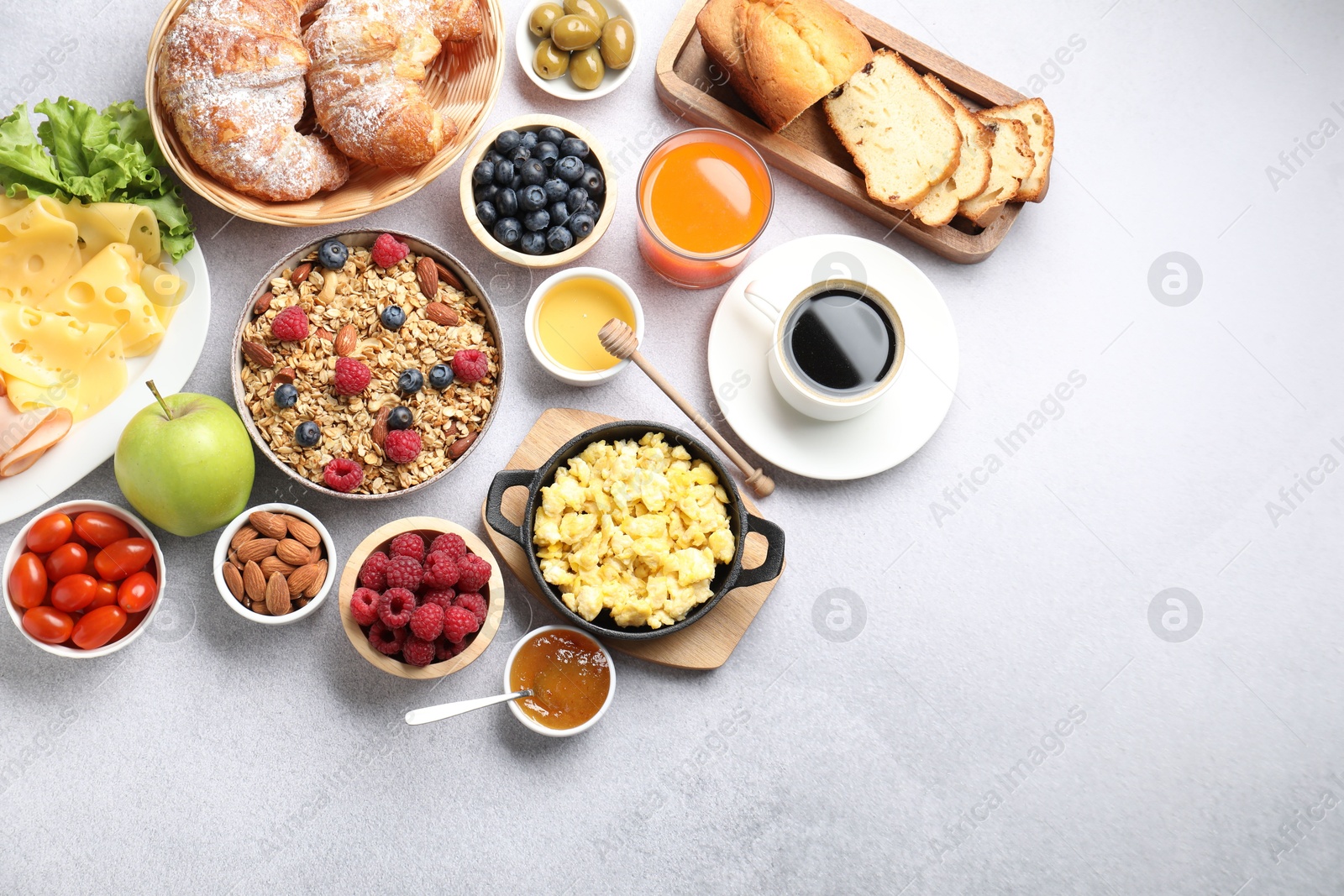 Photo of Tasty breakfast. Flat lay composition with many different food and drinks on grey textured table. Space for text