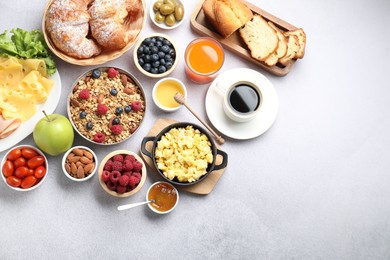 Photo of Tasty breakfast. Flat lay composition with many different food and drinks on grey textured table. Space for text