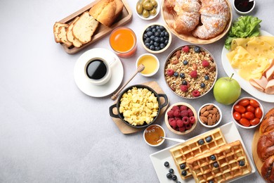 Photo of Tasty breakfast. Flat lay composition with many different food and drinks on grey textured table. Space for text