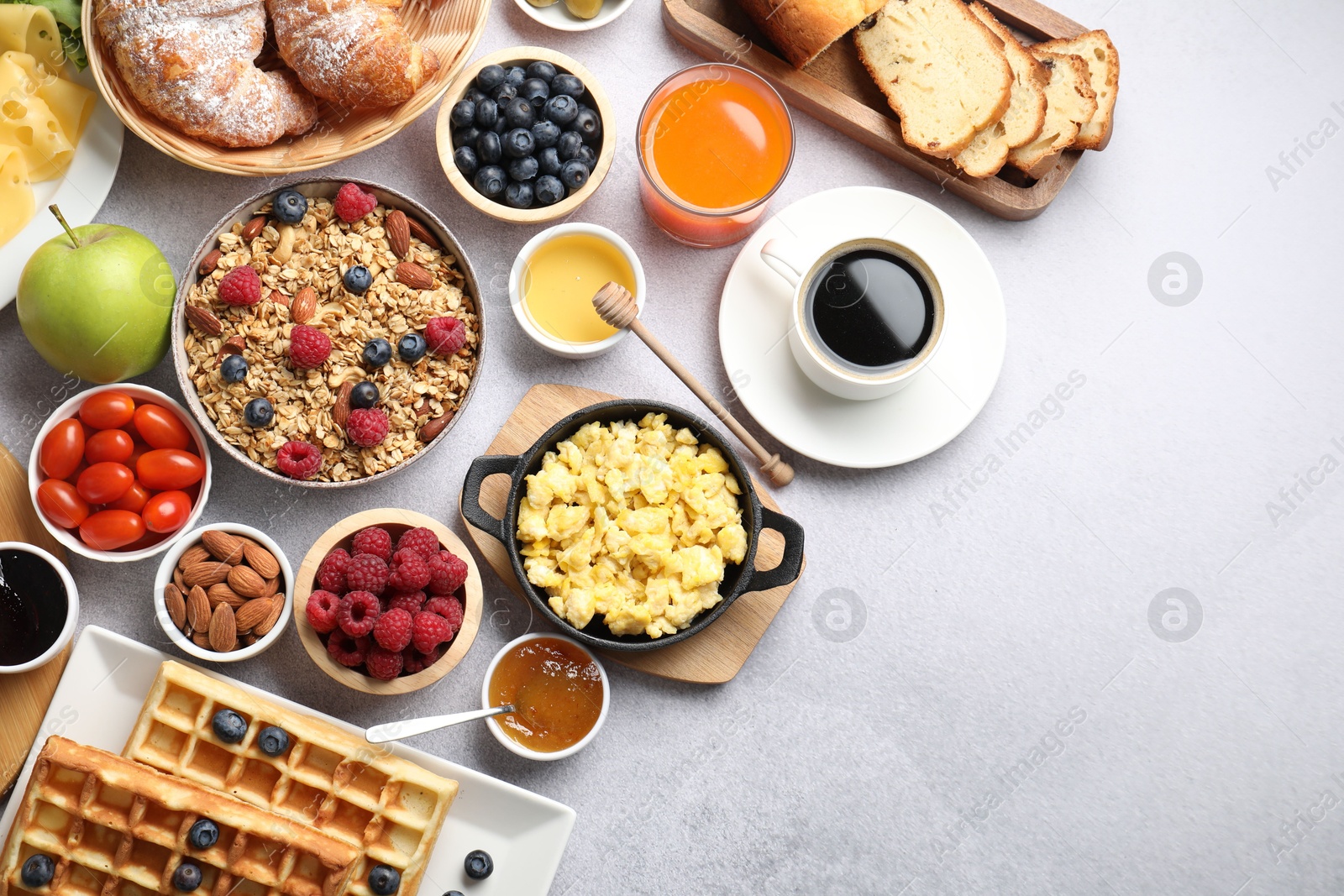 Photo of Tasty breakfast. Flat lay composition with many different food and drinks on grey textured table. Space for text