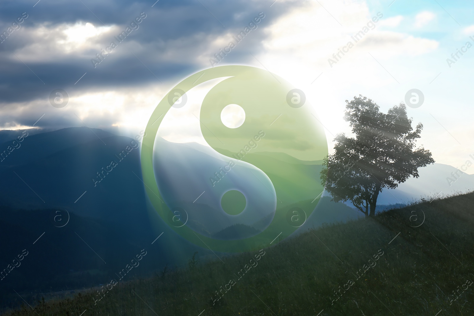 Image of Yin and yang symbol against picturesque mountain landscape