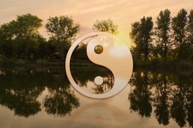 Image of Yin and yang symbol against picturesque nature landscape