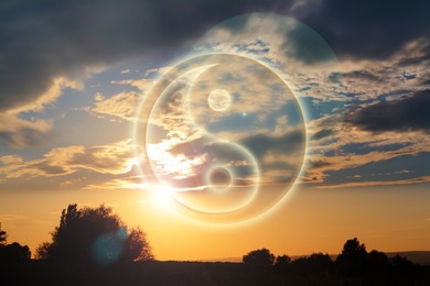 Image of Yin and yang symbol against picturesque nature landscape