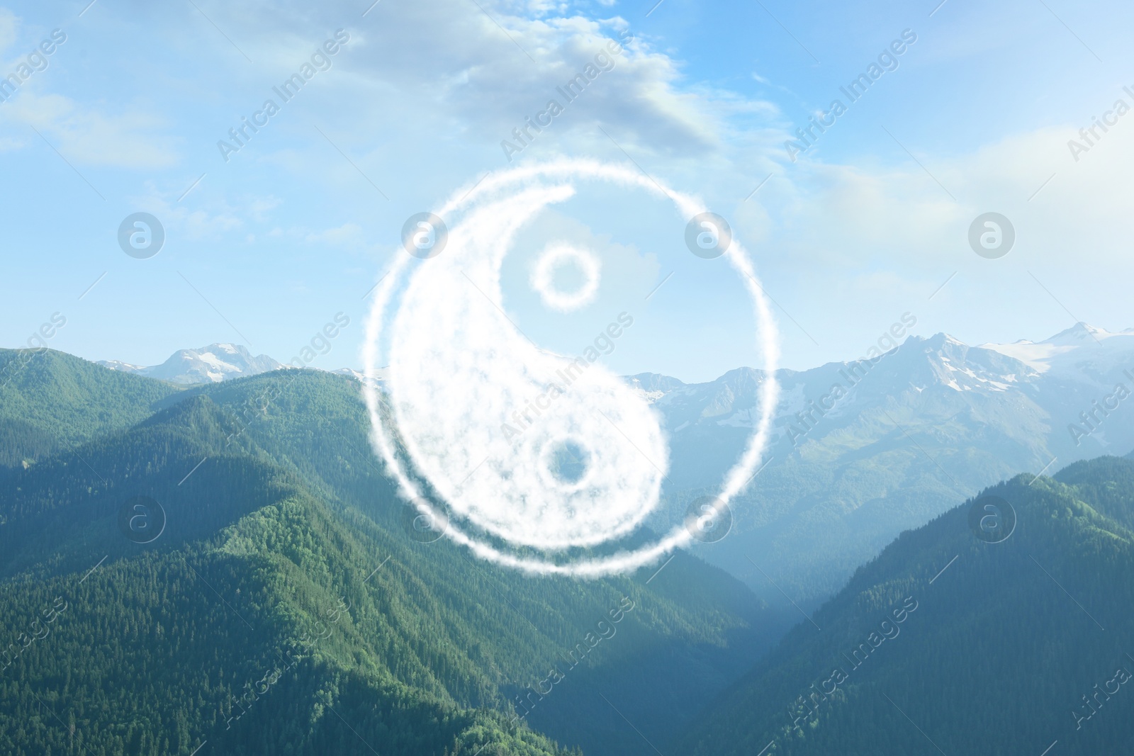 Image of Yin and yang symbol against picturesque mountain landscape