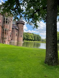 Utrecht, Netherlands - June 17, 2024: Beautiful De Haar castle, lake and tree outdoors