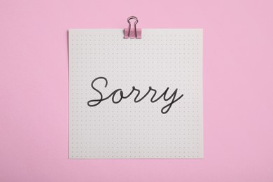 Image of Sorry paper note on pink background, top view