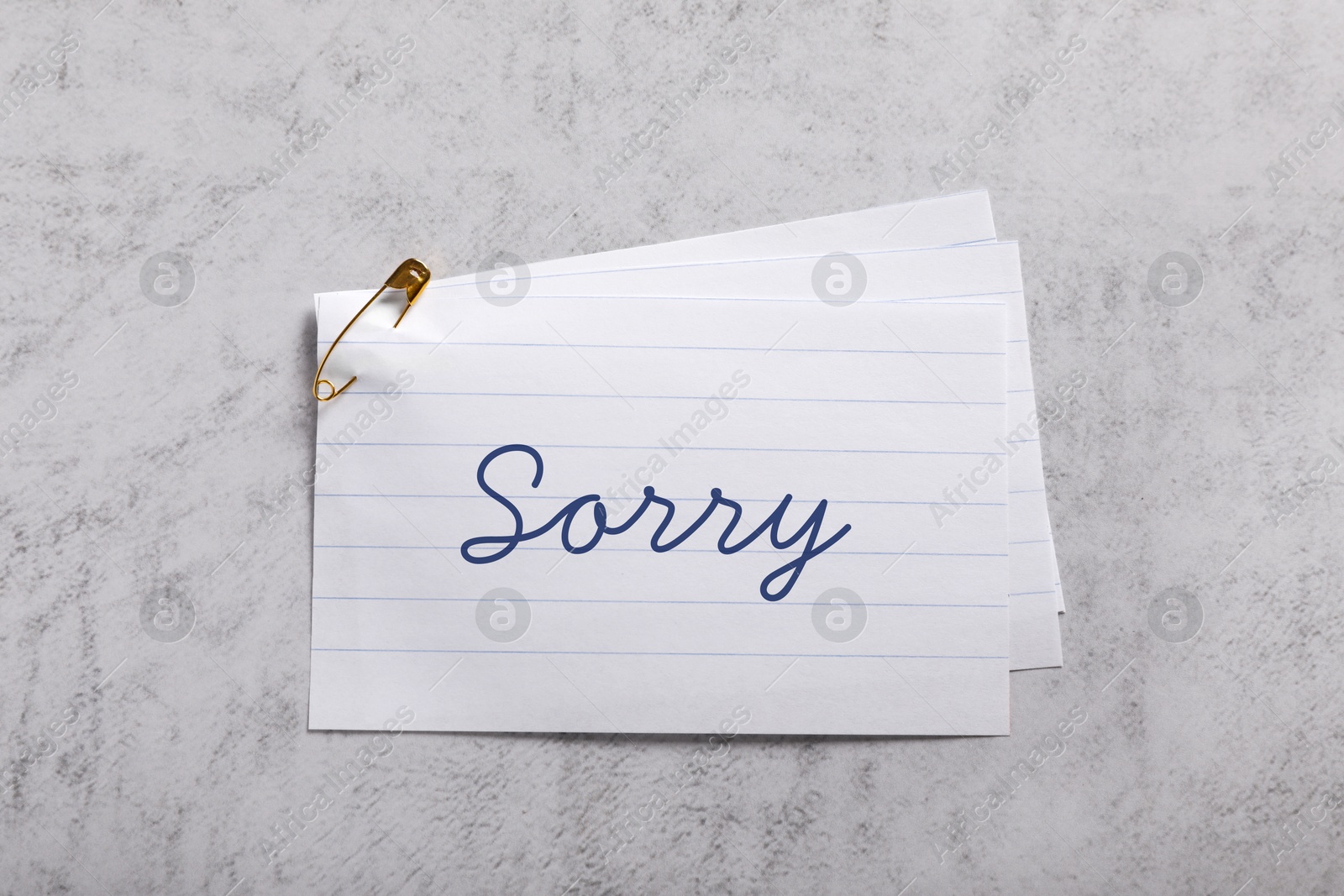 Image of Sorry paper note on grey table, top view