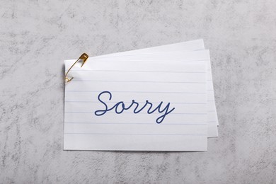 Image of Sorry paper note on grey table, top view