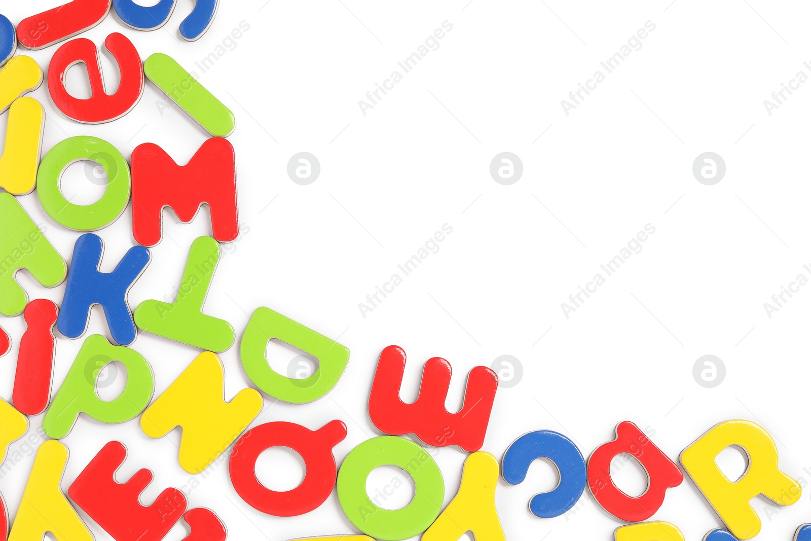 Photo of Alphabet. Many colorful magnetic letters isolated on white, top view