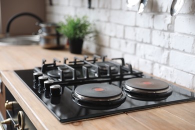 New modern stove with gas and electric burners in kitchen