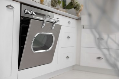Photo of New modern oven in stylish kitchen. Cooking appliance