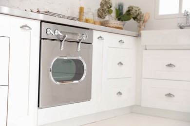 Photo of New modern oven in stylish kitchen. Cooking appliance