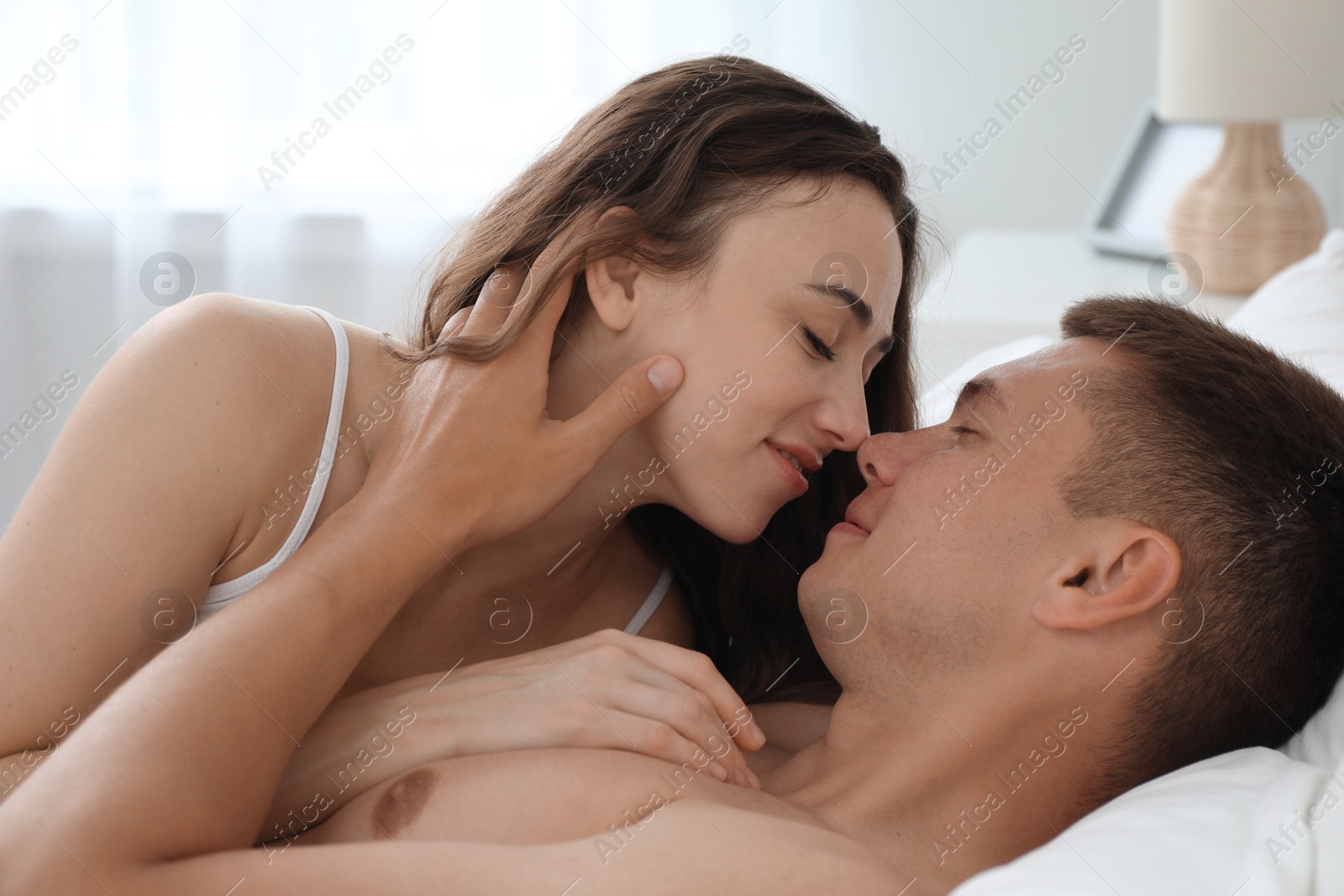 Photo of Lovely couple lying in bed at home