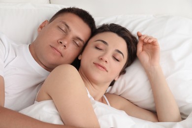 Lovely couple sleeping together in bed at home