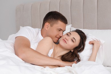 Lovely couple spending time together in bed