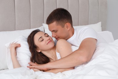 Photo of Lovely couple spending time together in bed