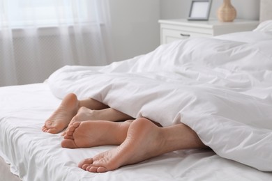 Lovely couple lying in bed at home, closeup view