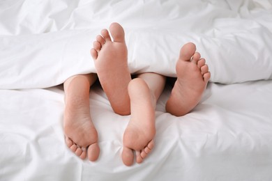 Lovely couple lying in bed, closeup view