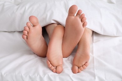 Lovely couple lying in bed, closeup view