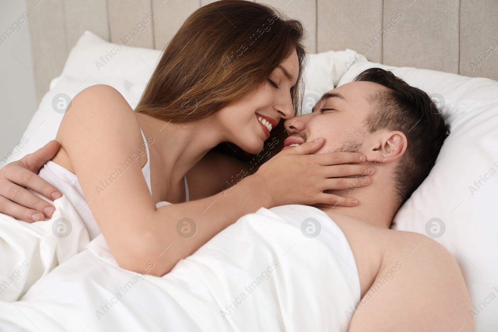 Photo of Lovely couple enjoying time together in bed at morning