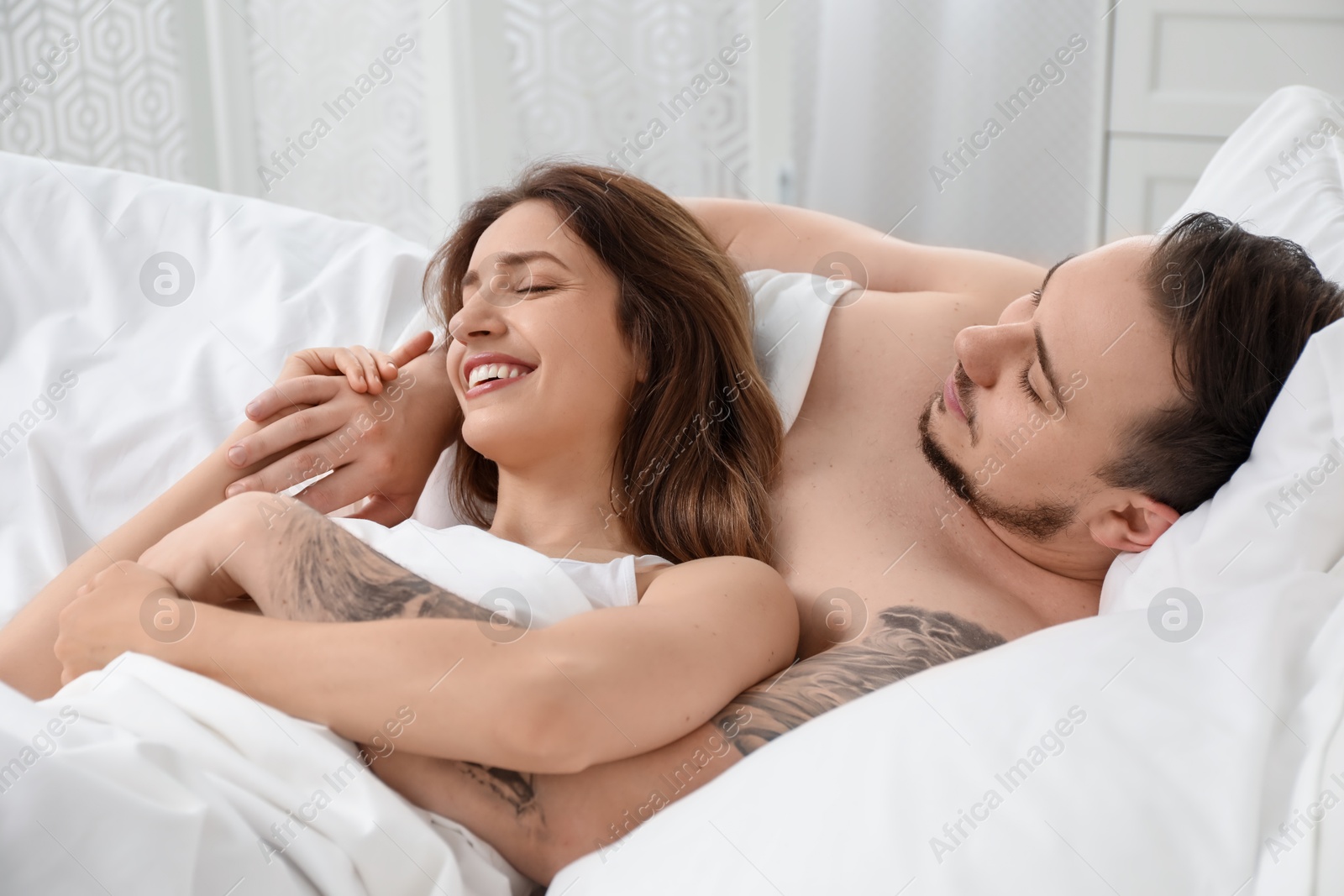 Photo of Lovely couple enjoying time together in bed at morning