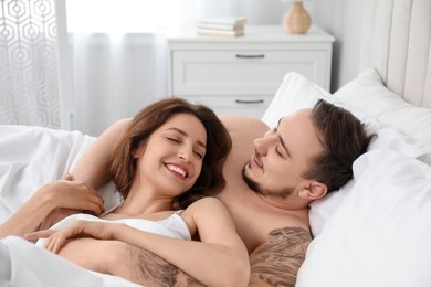 Photo of Lovely couple enjoying time together in bed at morning