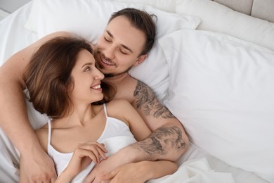 Lovely couple enjoying time together in bed at morning