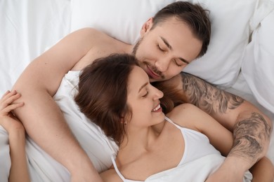 Lovely couple enjoying time together in bed at morning