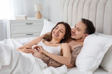 Photo of Lovely couple enjoying time together in bed at morning