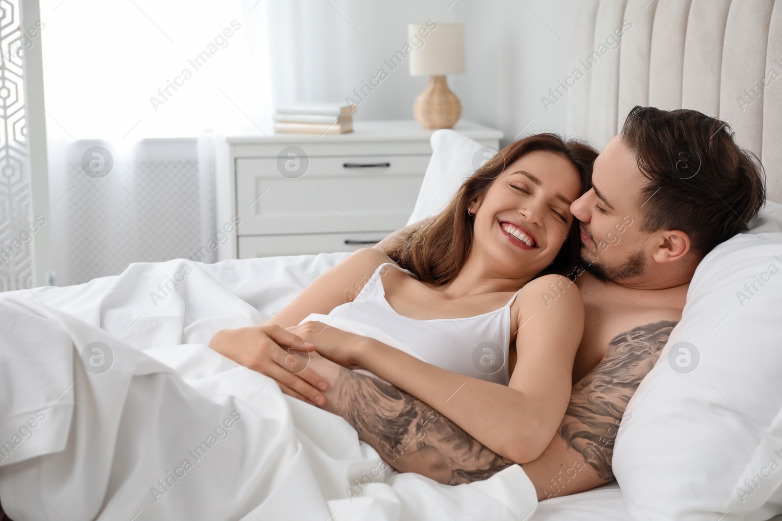 Photo of Lovely couple enjoying time together in bed at morning