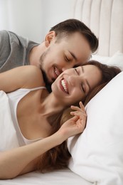 Photo of Lovely couple enjoying time together in bed at morning