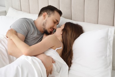 Photo of Lovely couple enjoying time together in bed at morning