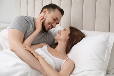 Lovely couple enjoying time together in bed at morning