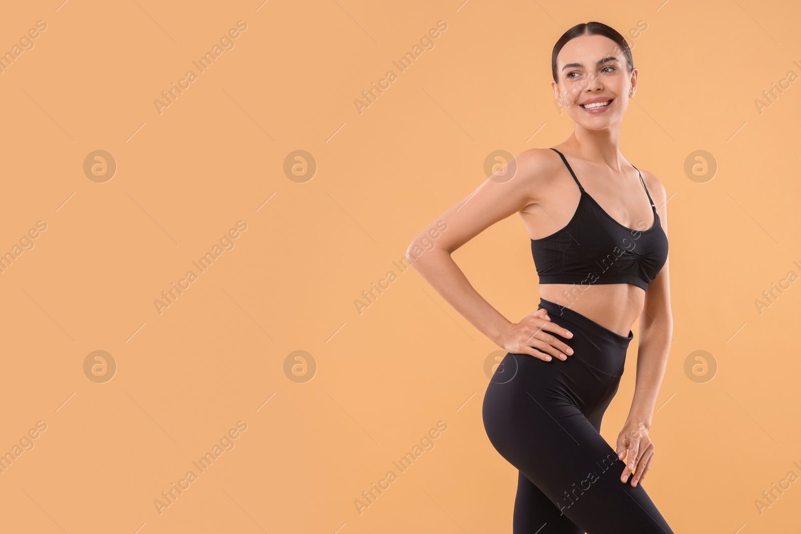 Photo of Diet and weight loss concept. Beautiful young woman with slim body against beige background, space for text