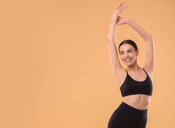 Photo of Diet and weight loss concept. Beautiful young woman with slim body against beige background. Space for text