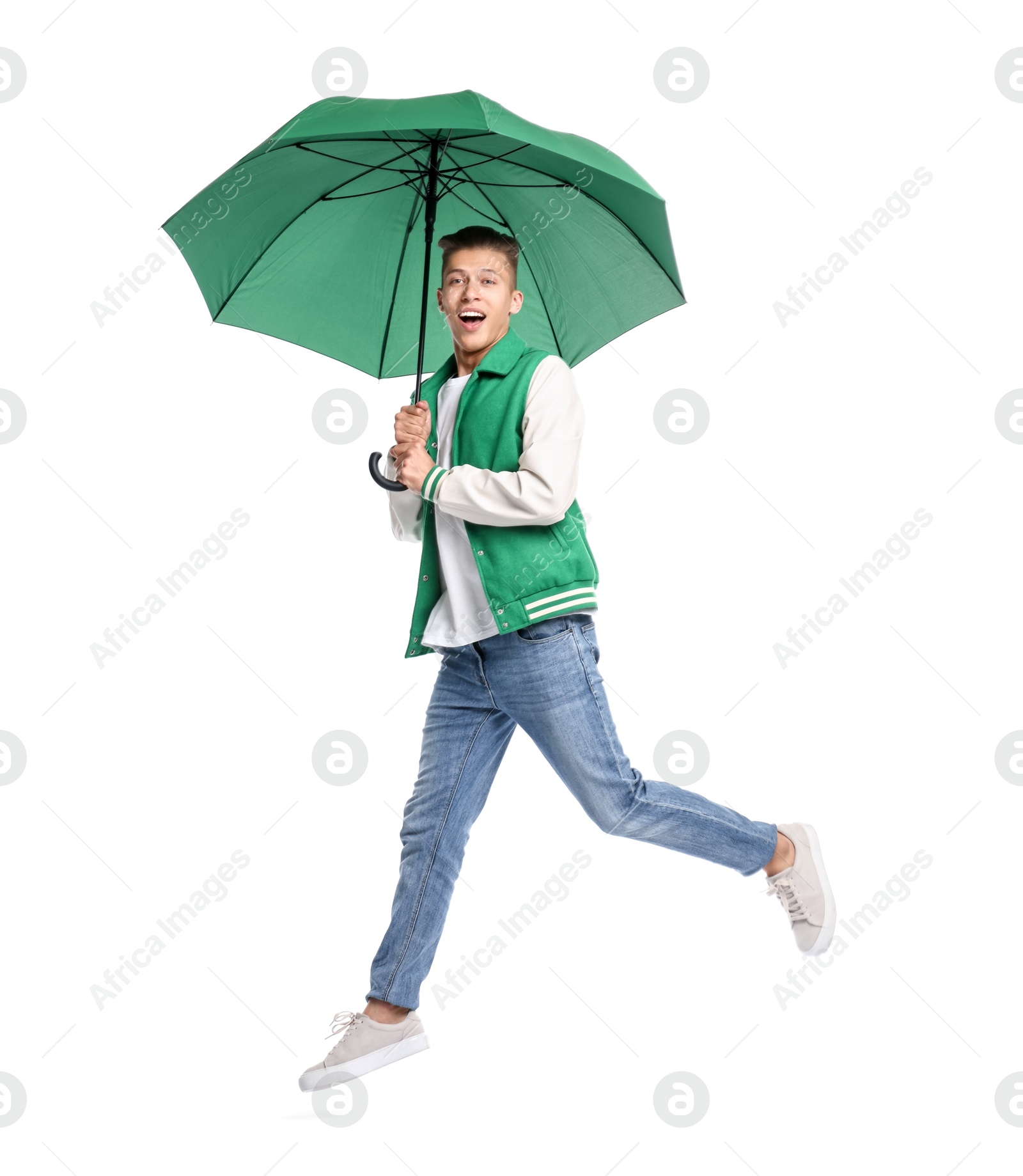 Photo of Young man with green umbrella jumping on white background