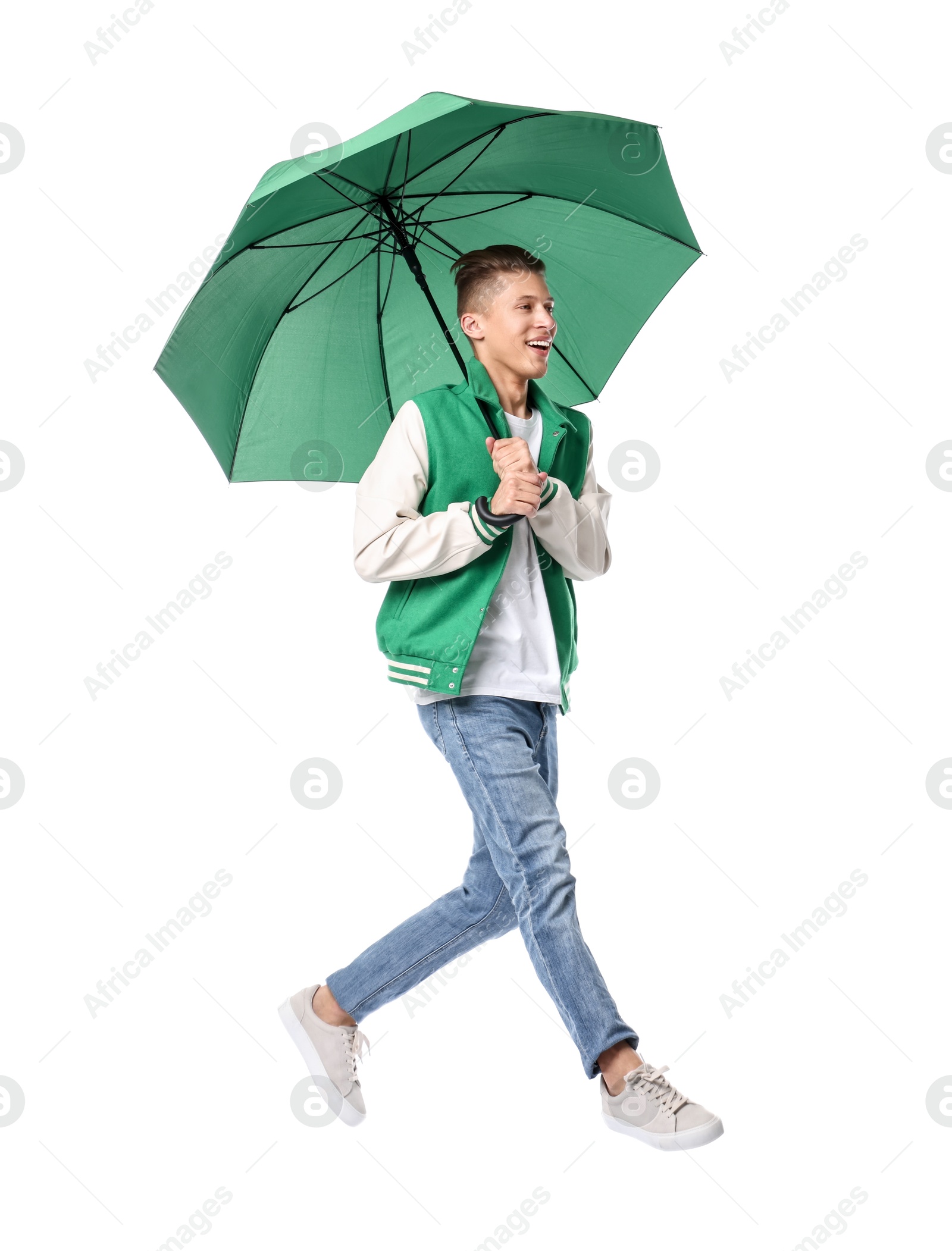 Photo of Young man with green umbrella jumping on white background