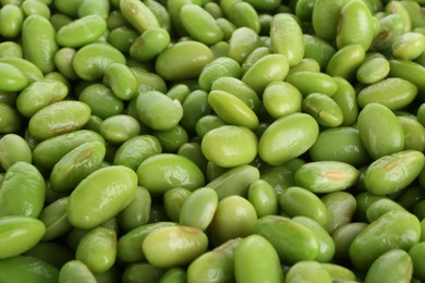 Photo of Raw green edamame soybeans as background, closeup