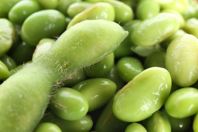 Photo of Raw green edamame pod and soybeans as background, closeup