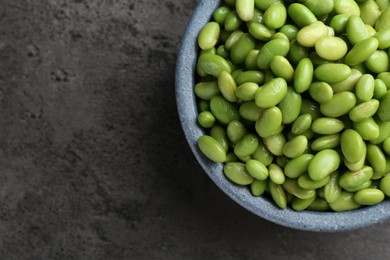 Photo of Raw green edamame soybeans on grey table, top view. Space for text