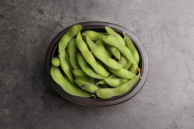 Photo of Raw green edamame pods on grey table, top view