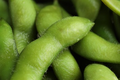 Photo of Fresh edamame pods as background, closeup view