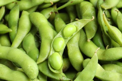 Photo of Fresh edamame pods with soybeans as background, above view