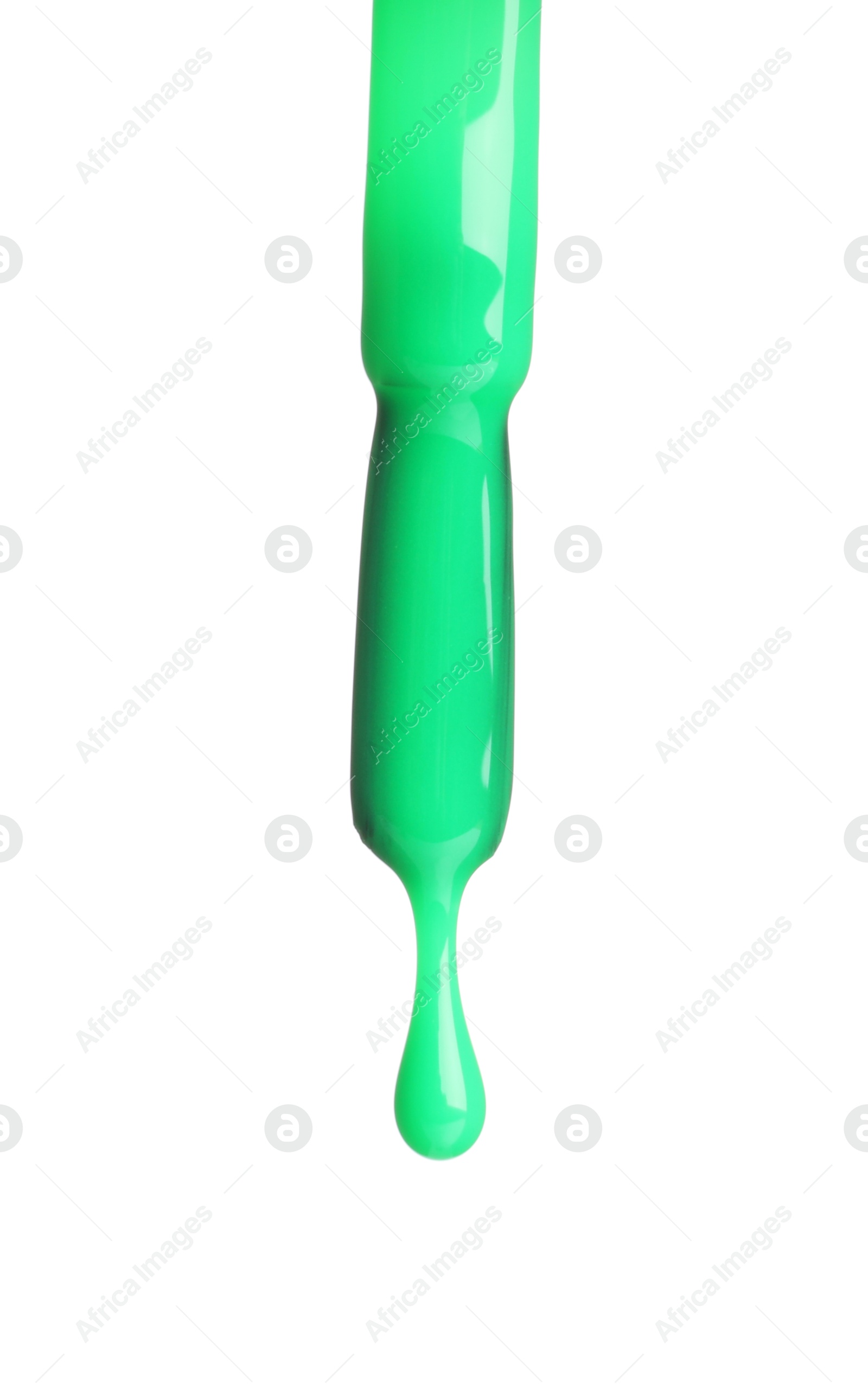 Photo of Green nail polish dripping from brush isolated on white