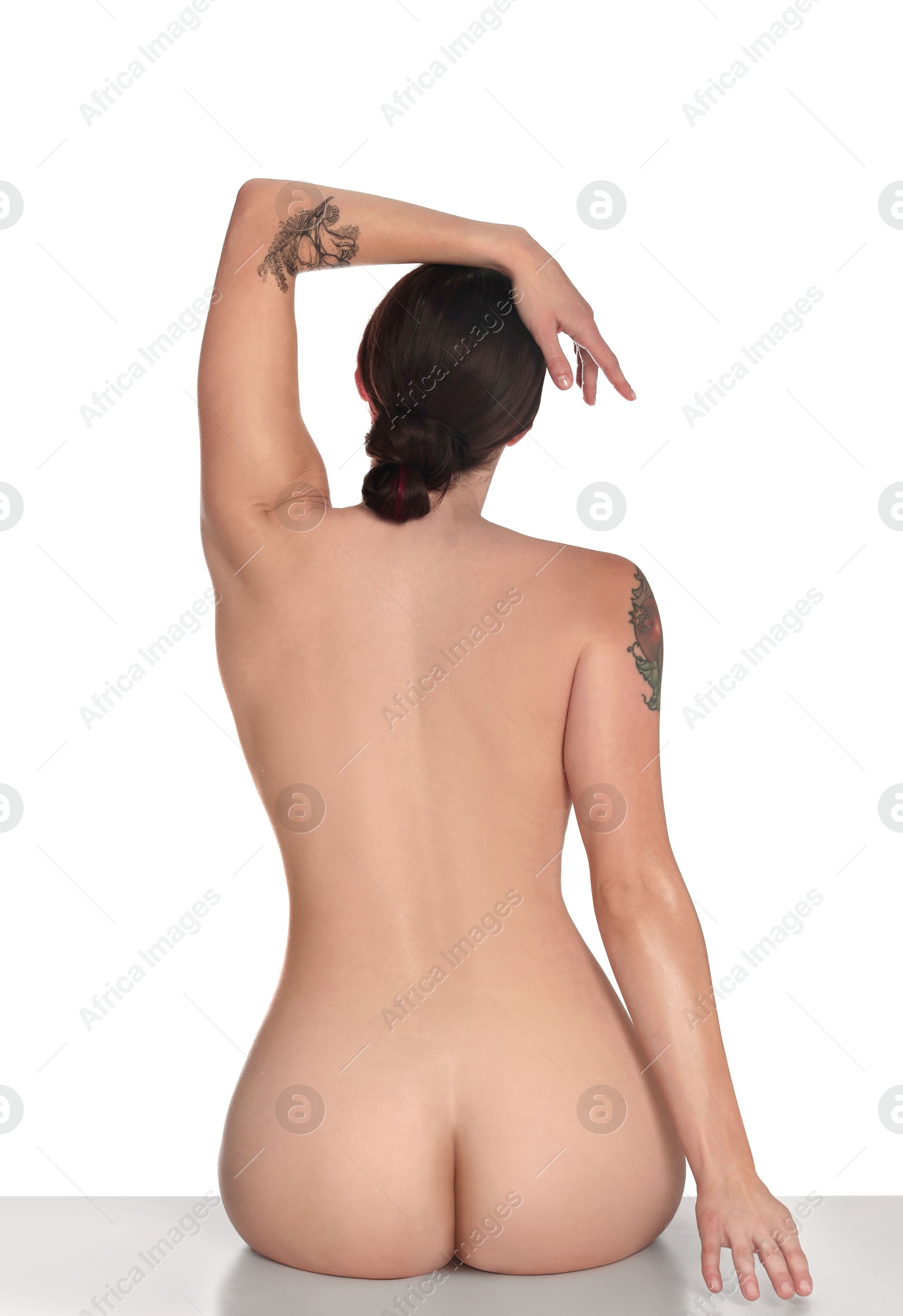 Photo of Nude woman posing on white background, back view