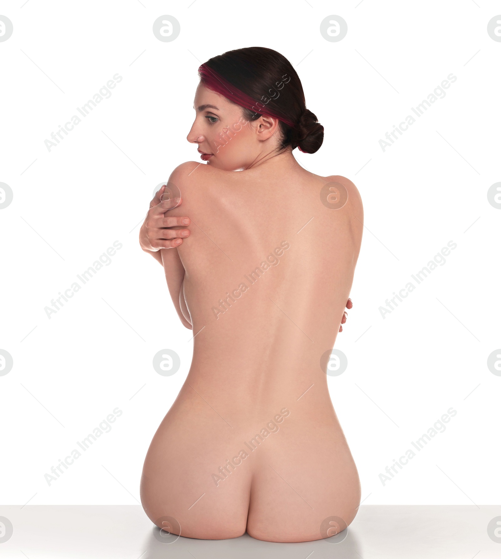Photo of Nude woman posing on white background, back view